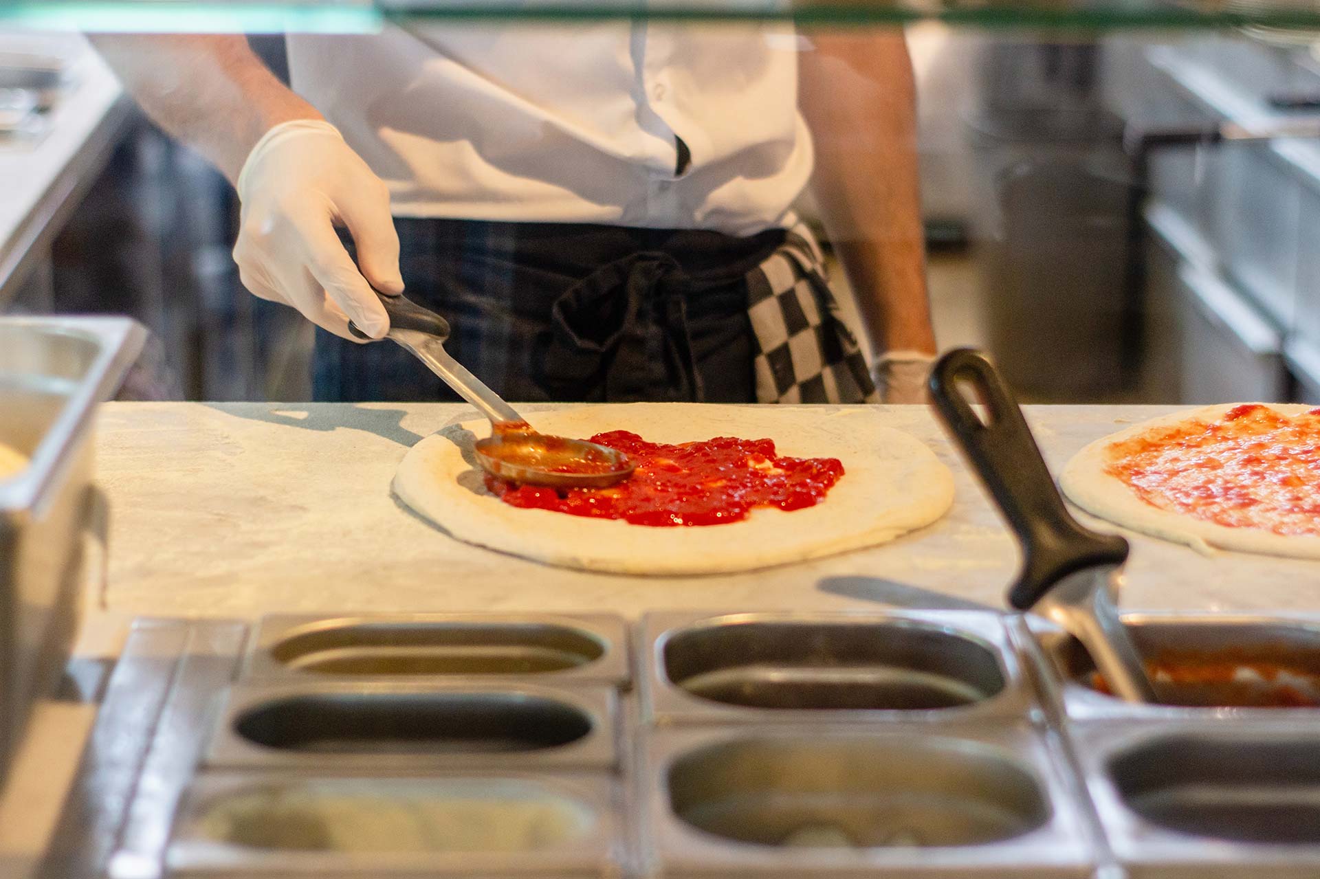 man in restaurant making pizza